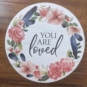 Round wooden container with floral design and “you are loved” text